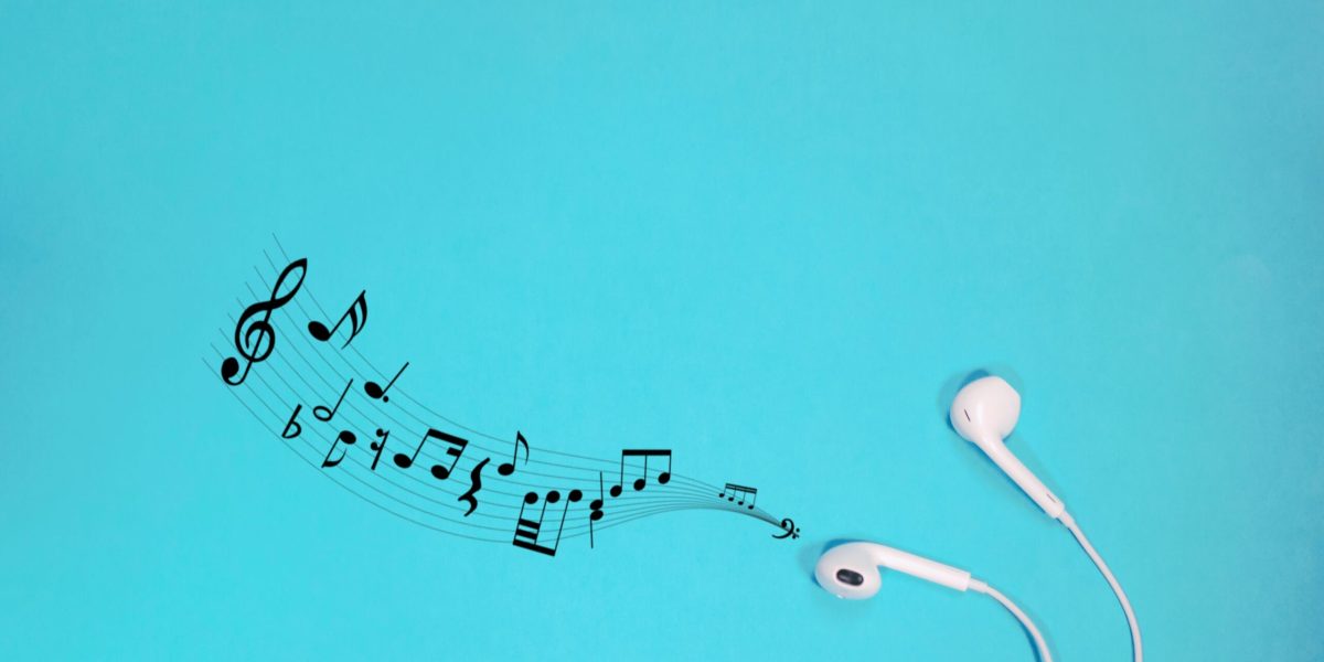 white earphones with notes on a blue background